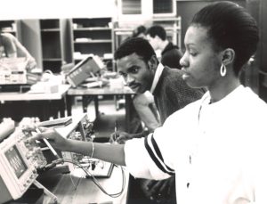 Candid photograph of two African-American students working in an electronics laboratory
