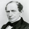 A head shot of Johns Hopkins. He looks at the camera from an angle and wears a dark colored suit.