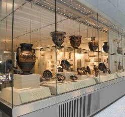 Photo of glass display cases showing ancient vases and bowls.